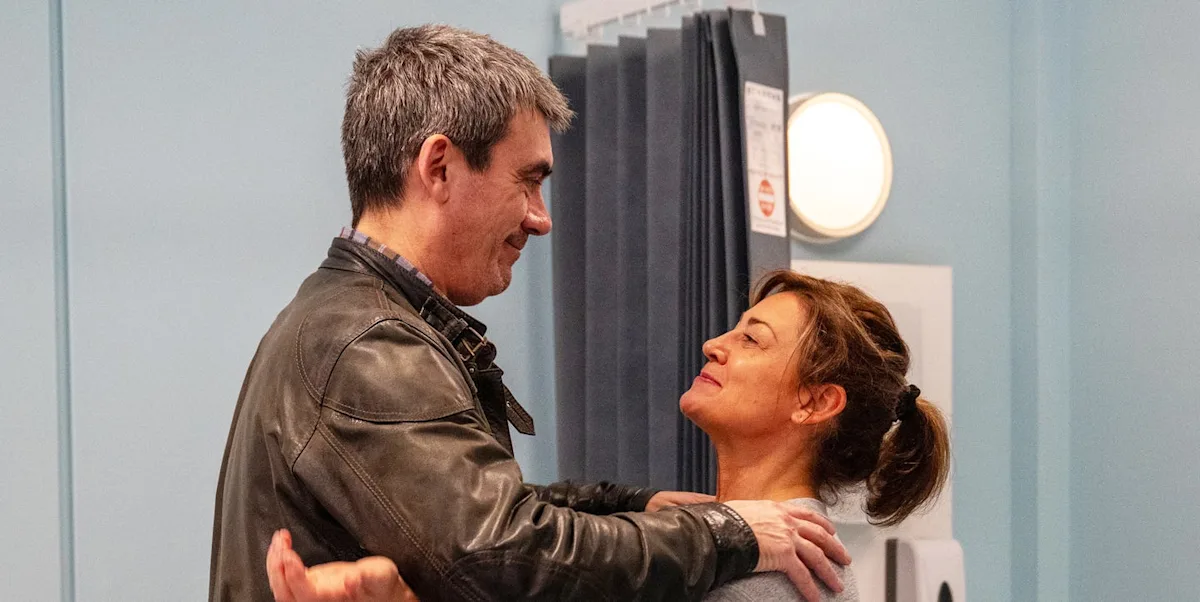 Moira Dingle stands in the village of Emmerdale, looking concerned as she analyses the latest development in her life, with the colour of the village changing around her, as the news of her breakthrough spreads, Emmerdale