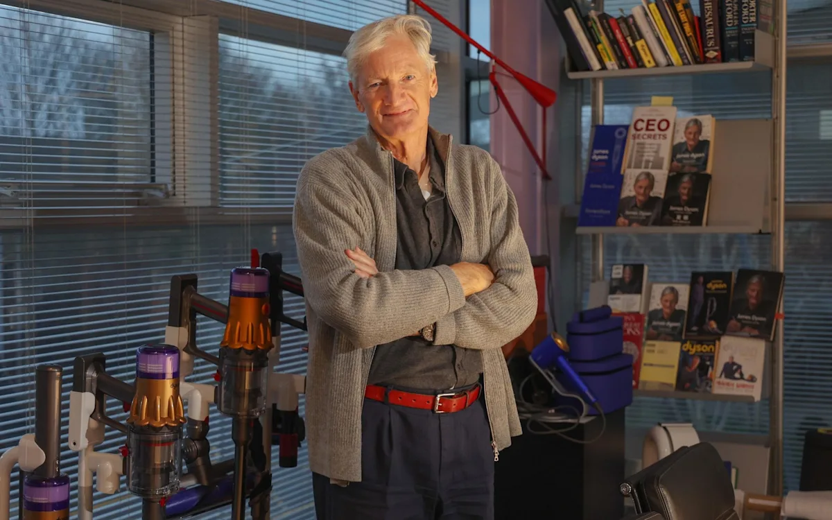 James Dyson, founder of Dyson Ltd, speaking at a business conference, with a background of Dyson products, highlighting the company's innovative approach to technology and design, as he accuses Labour of 'revenge economics'