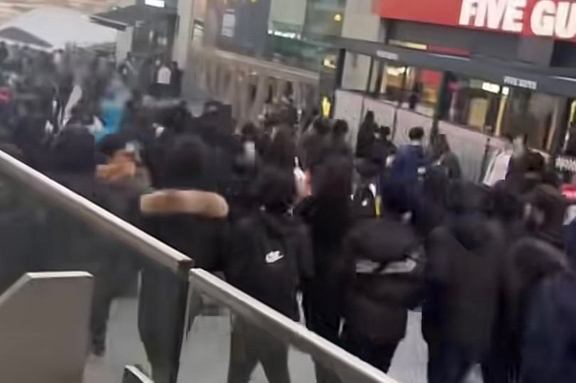 Schoolchildren running riot near the Bullring shopping centre, with shops closed and shoppers looking on in fear, the primary keyword is Bullring chaos