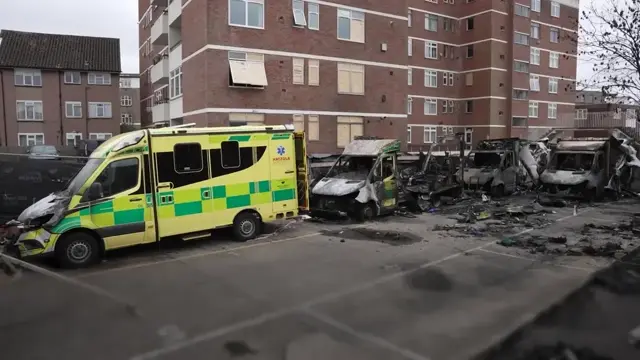 A photo of a damaged ambulance with a caption describing the alleged arson attack on Jewish community ambulances, highlighting the importance of protecting emergency services and promoting community cohesion