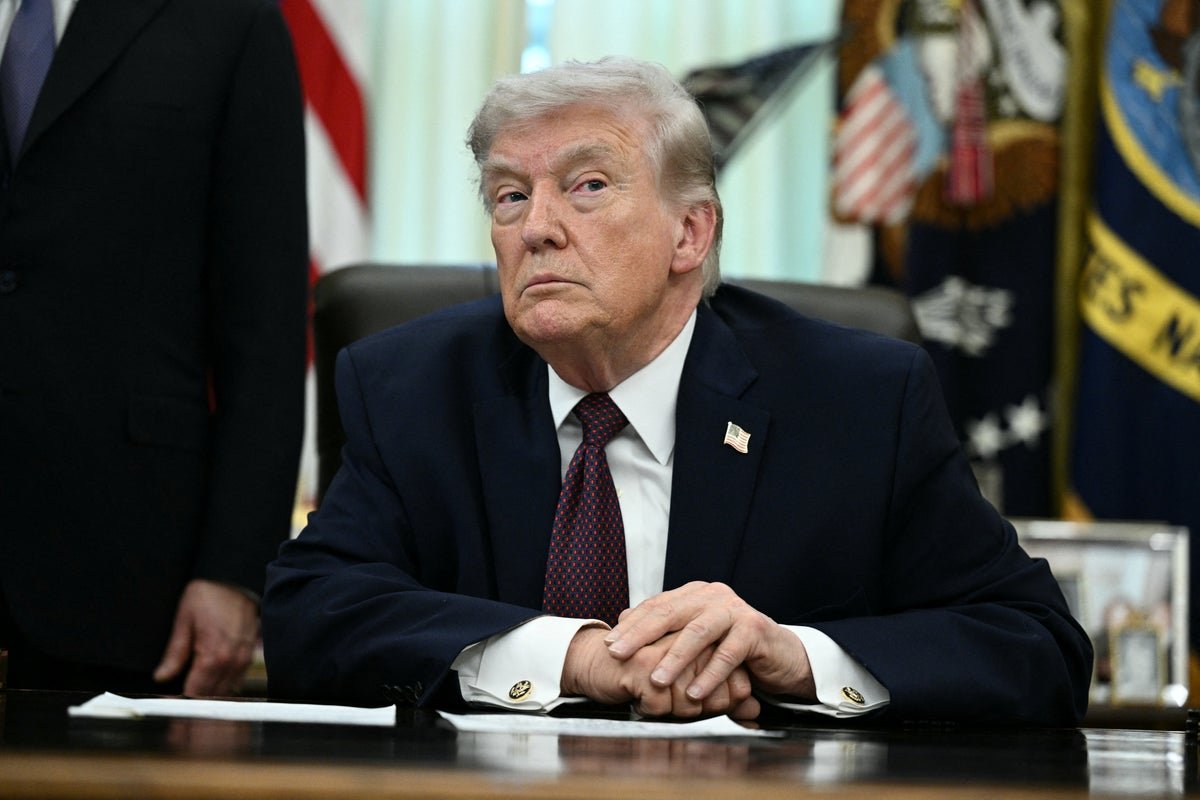 President Trump speaking at a press conference, with a backdrop of American and Iranian flags, symbolising the complex relationship between the two nations, and the ongoing debate about Iran's uranium enrichment programme, a key factor in the US's stance on Iran