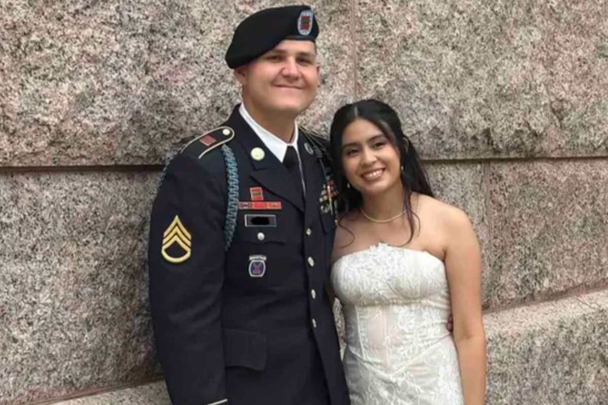 A newlywed couple standing in front of a US military base, with a sombre expression, representing the primary keyword phrase 'ICE arrests'