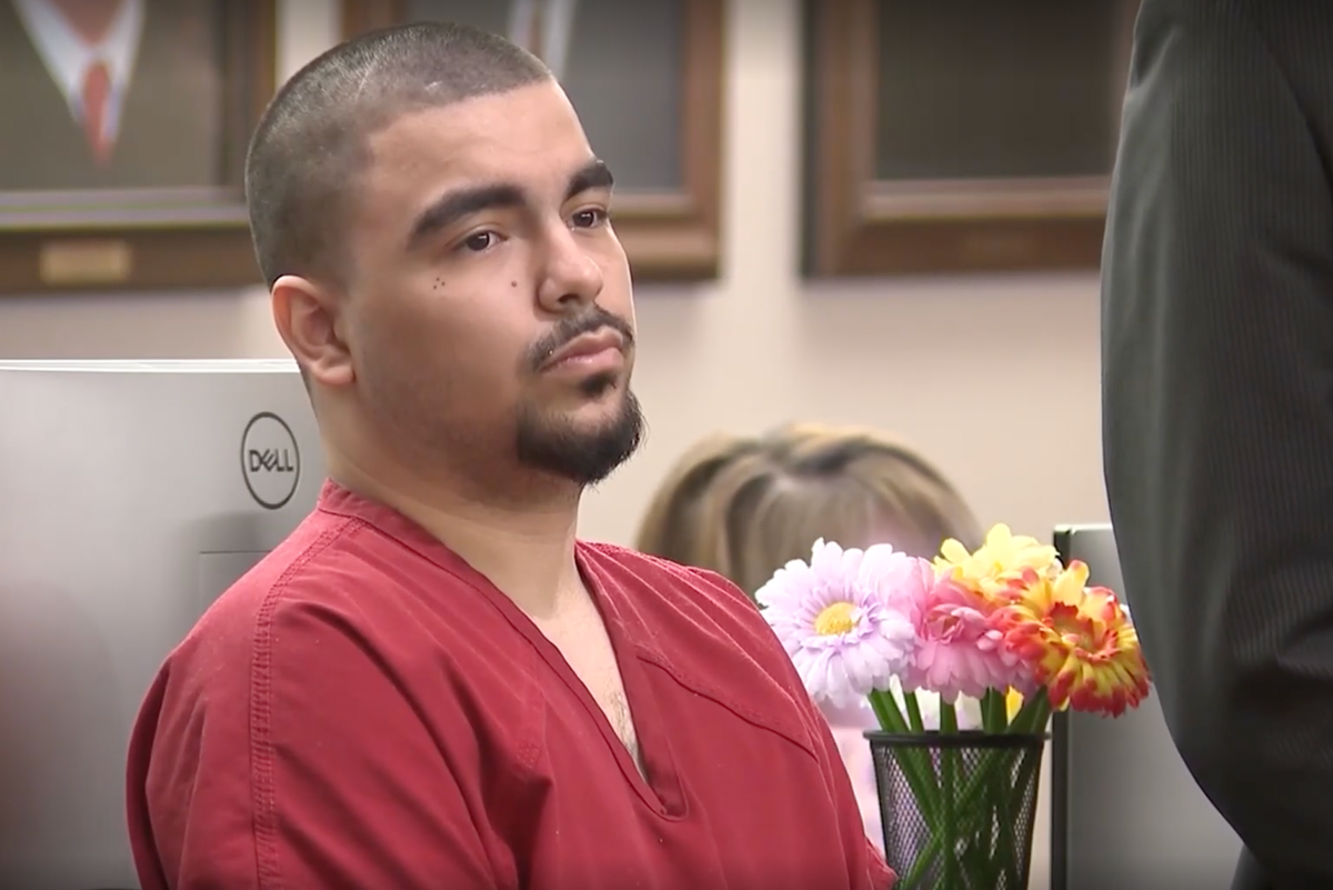A man in a prison cell, with a sombre expression, highlighting the severity of the crime and the importance of addressing domestic violence