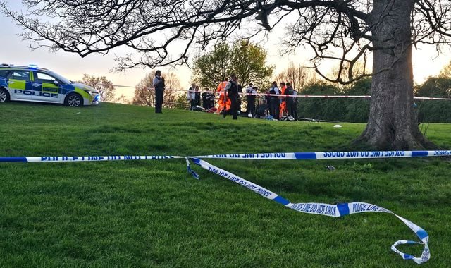 Aerial view of Primrose Hill viewpoint in London, with people gathered in the distance, a poignant reminder of the tragic stabbing incident that occurred at this popular destination, highlighting the need for increased safety measures and community awareness