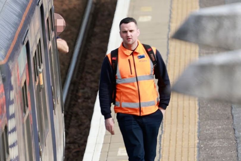 A ScotRail train driver in uniform, with a blurred background of a train in motion, highlighting the importance of trust and safety in the role, with the primary keyword phrase 'train driver job' included naturally
