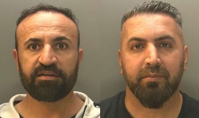 A car wash business used as a front for human smuggling, with a group of people in the background looking worried and scared, as the primary keyword 'human smuggling' is used to describe the scene