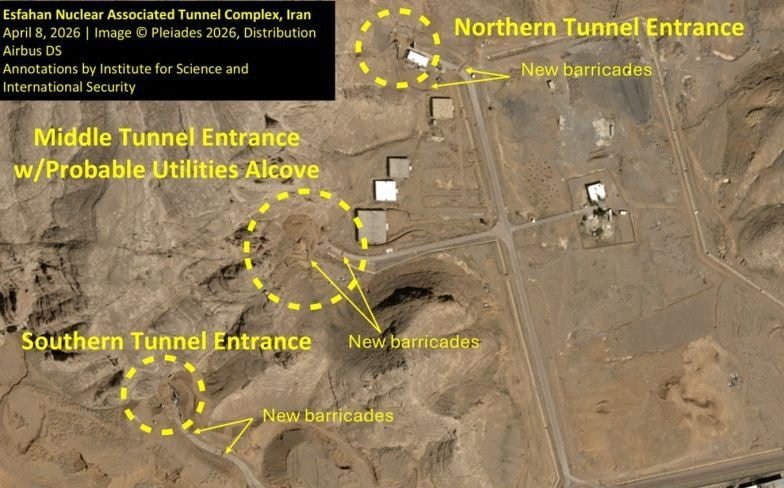 Iranian workers constructing roadblocks at a nuclear site to prevent potential ground attack, with a focus on defence and security measures, highlighting the primary keyword phrase Iran nuclear site
