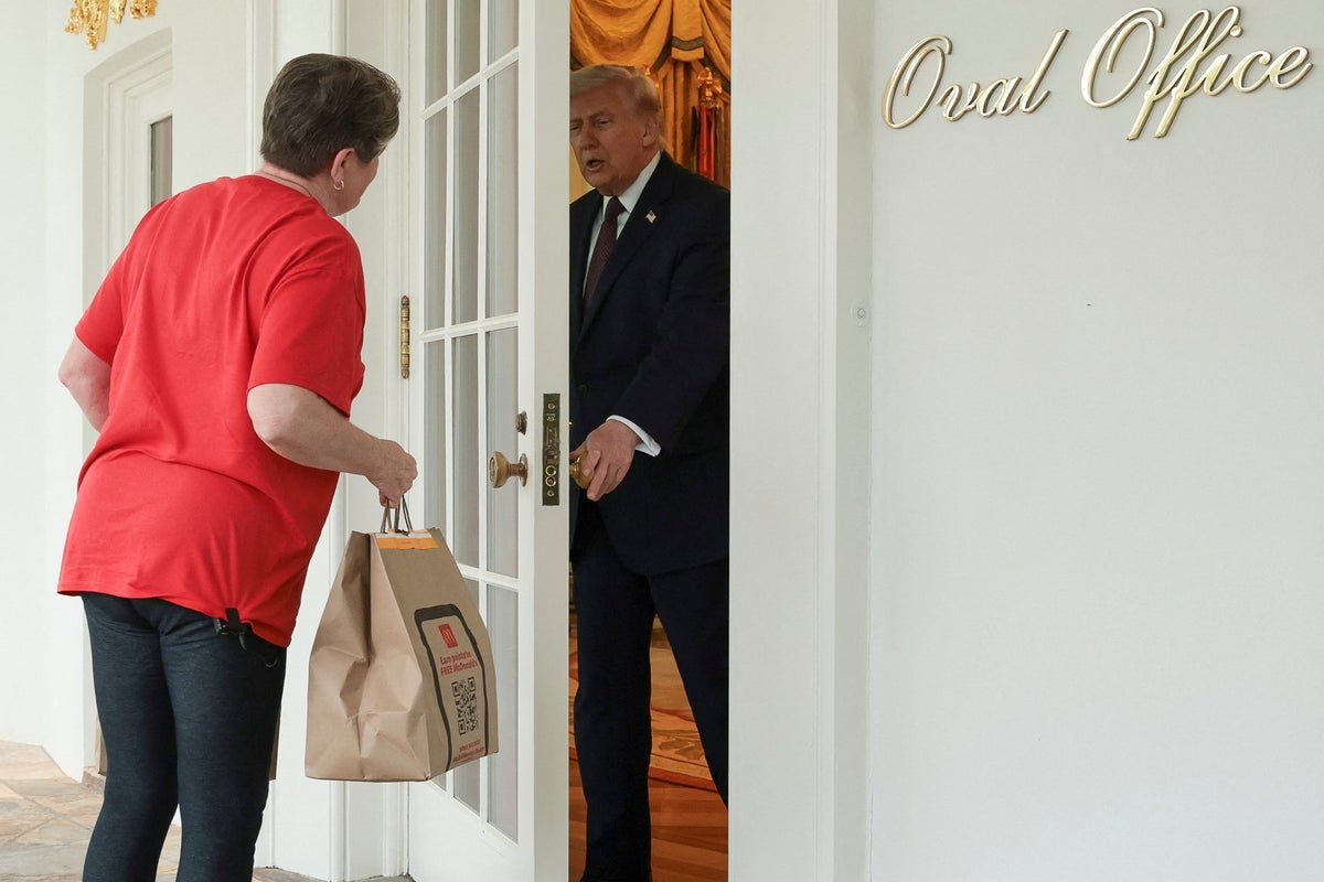 Donald Trump holding a McDonald's bag with the White House in the background, symbolising his unconventional approach to politics and the ongoing Iran war debate