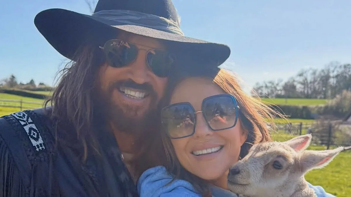 Elizabeth Hurley and Billy Ray Cyrus share a romantic moment on their anniversary, beaming with happiness and love, a perfect example of relationship goals, with a beautiful colour palette and charming behaviour