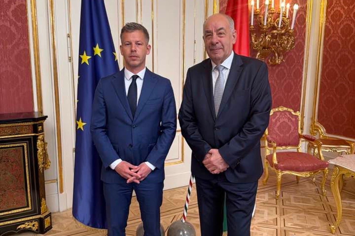 Hungarian Prime Minister and President pose for a photograph before the PM's astonishing attack, calling for the President's resignation amidst political turmoil in Hungary
