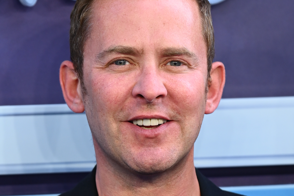 BBC Radio 2 studio with a presenter at the microphone, preparing for a live broadcast with a colourful background and a lively atmosphere, highlighting the station's vibrant personality and commitment to entertainment