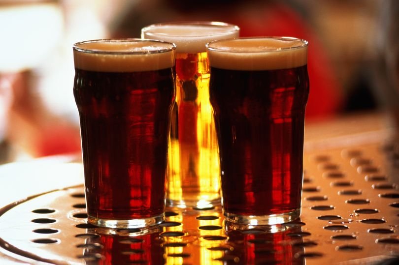 A group of friends laughing and having fun while participating in a quiz night, with a bowl of snacks and drinks on the table, the primary keyword is pub quiz questions