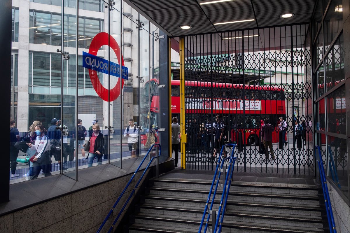 A crowded London tube station with a sign stating 'tube strike' in the foreground, highlighting the impact of the RMT union's decision to go ahead with the walkout on London's transport network