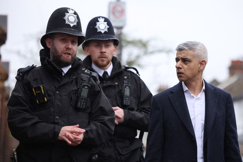 A person caught shoplifting in London, with a police officer in the background, highlighting the primary keyword of shoplifting in the city