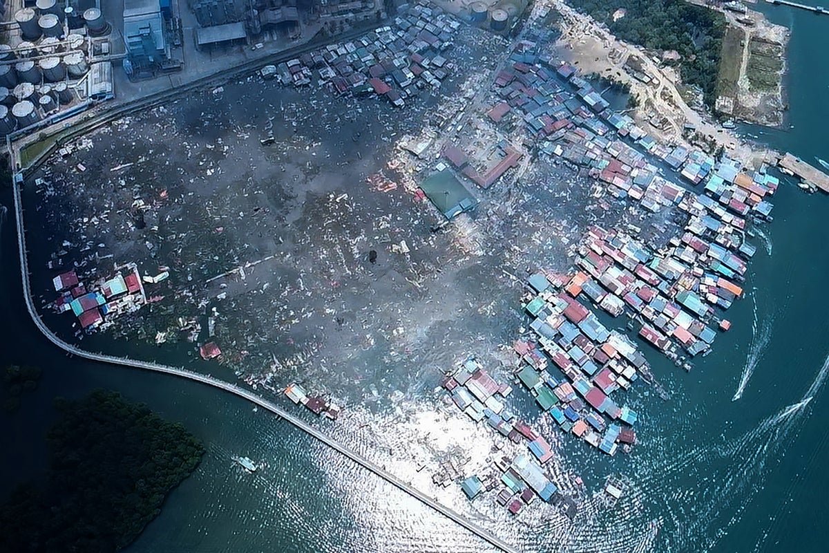 Aerial view of Malaysian water village after fire, with destroyed homes and debris scattered everywhere, highlighting the devastating impact of the disaster on the community