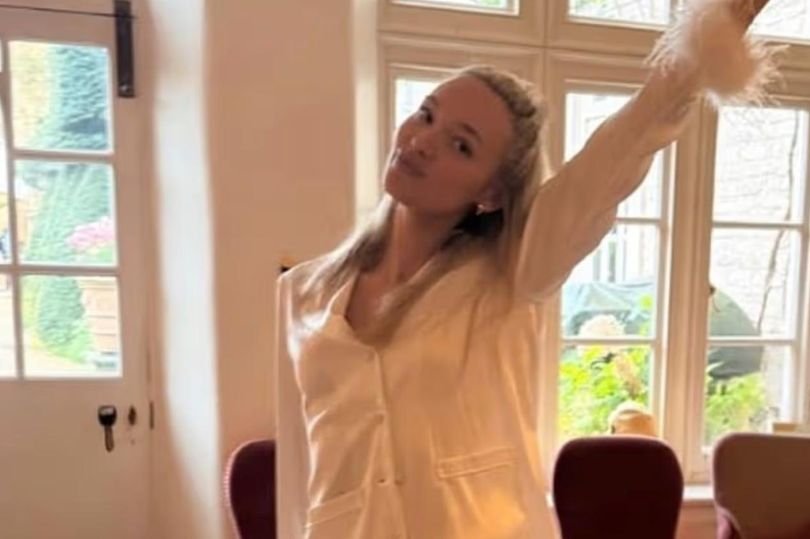 Roxy Horner and Jack Whitehall exchange vows on their wedding day, surrounded by lush greenery and beautiful decorations, a truly magical moment, with Roxy looking stunning in her wedding gown and Jack beaming with happiness, a perfect capture of their love and commitment to each other