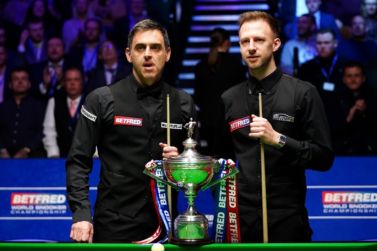 Ronnie O'Sullivan and Judd Trump in action at the World Snooker Championship, with Shaun Murphy looking on, as the snooker world watches with bated breath, awaiting the outcome of the controversy surrounding the big names in the sport
