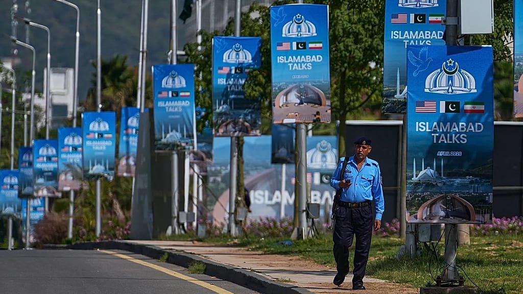 Iranian and US flags in the background, with a clock ticking away in the foreground, symbolising the looming ceasefire deadline and the urgent need for a diplomatic solution to the conflict