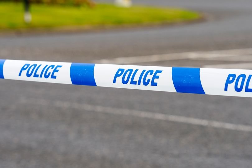 A police officer stands near a cordoned-off area in South London, where gunshots were heard during daylight hours, as authorities work to uncover the circumstances surrounding the incident and recover a weapon, with a focus on tackling gun crime