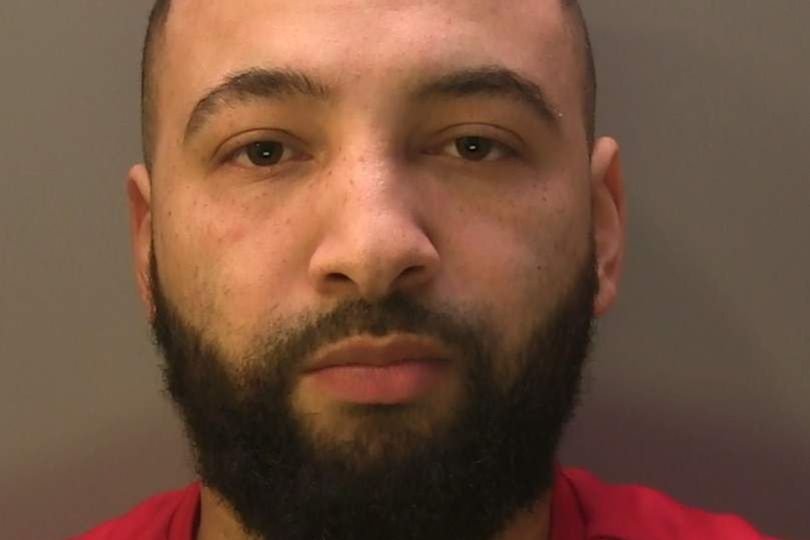 Featured image of a prison wall with a mobile phone and drugs thrown over it, highlighting the smuggling scandal in London prisons, with a focus on the primary keyword phrase 'prison smuggling'