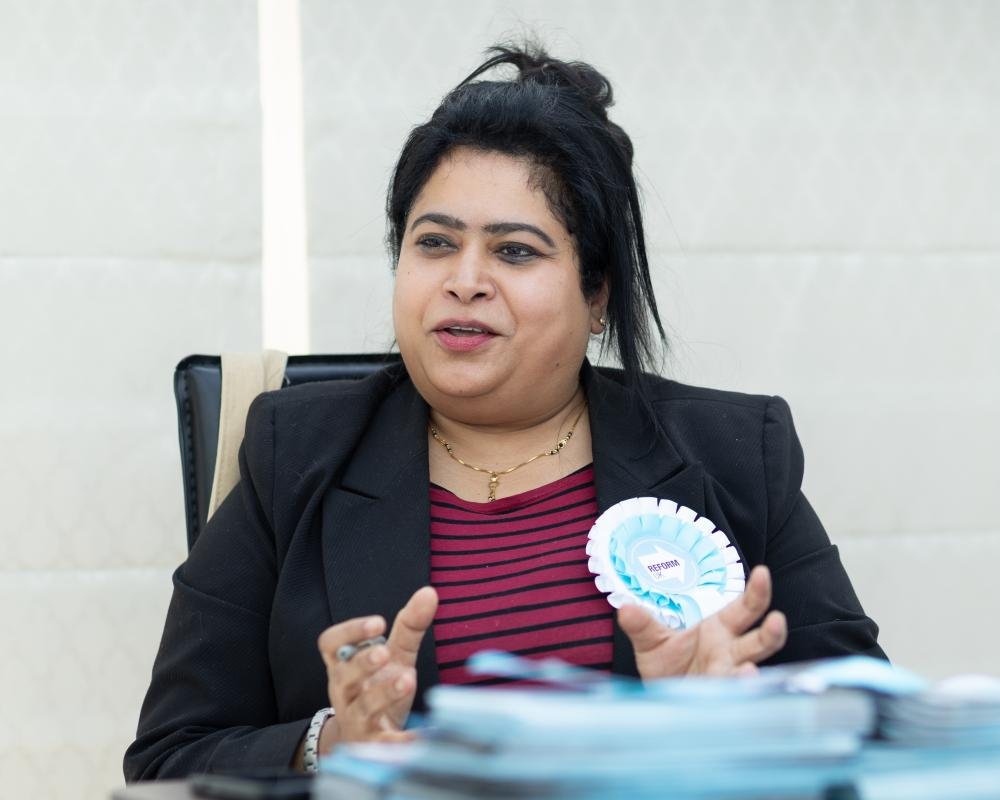British Indians marching in support of Nigel Farage, reflecting a change in political behaviour and allegiance among this demographic, with a mix of British and Indian flags, symbolising their dual identity and political shift