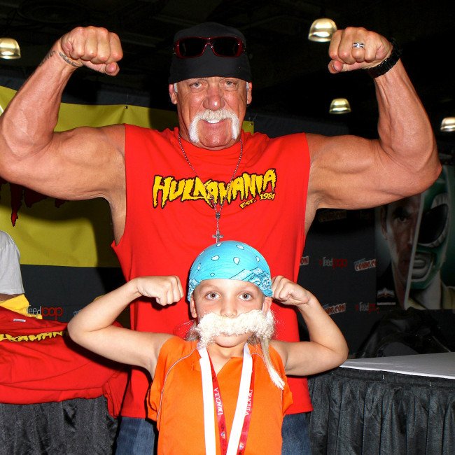 Hulk Hogan standing in the ring with his signature bandana and moustache, a testament to his enduring legacy as a wrestling legend and cultural icon