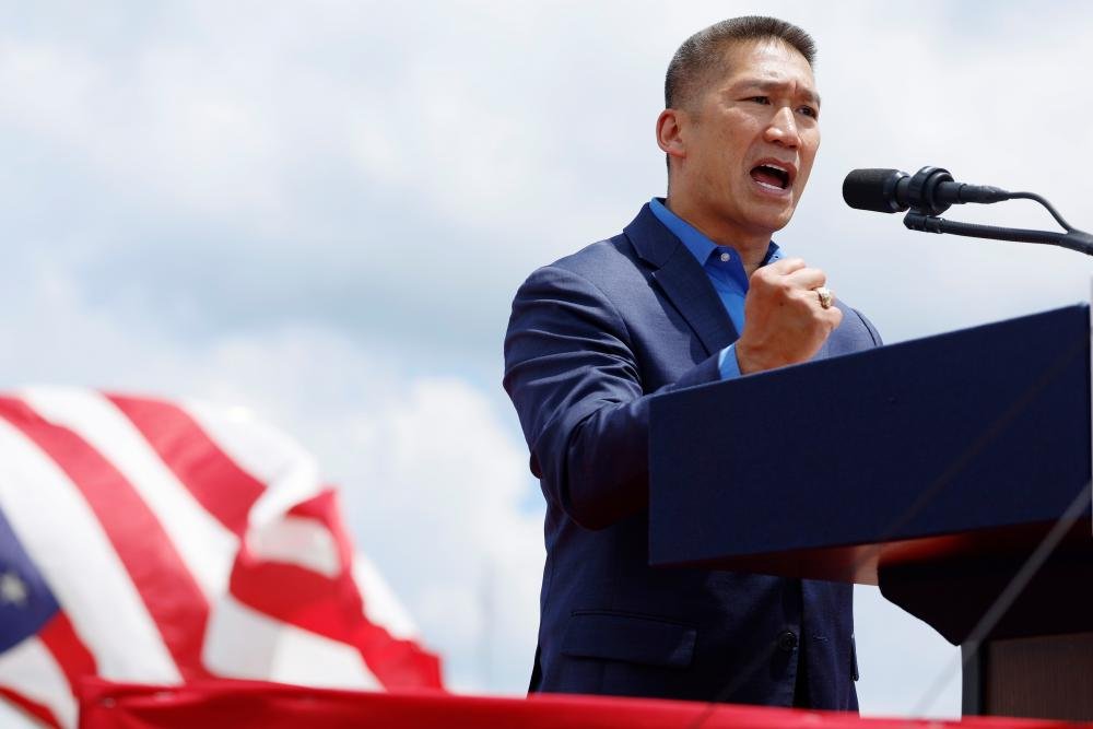Hung Cao, the former refugee turned Trump's acting navy secretary, smiling in his naval uniform, with a subtle background of the US flag, symbolising his new role and the country he now serves, with a sense of pride and honour, as he takes on the challenges of leading the US navy, with a strong sense of leadership and vision for the future, and a deep commitment to public service, as a former refugee who has risen to the top, his story is one of inspiration and hope, for all those who have faced adversity and overcome it, to achieve their goals and make a positive impact on the world, with a focus on the US navy and its operations, and the significance of Cao's appointment, as a new era of leadership and direction, for the US navy, and the country as a whole, with a sense of pride and honour, and a deep commitment to public service, and a strong sense of leadership and vision for the future, and a focus on the US navy and its operations, and the significance of Cao's appointment, as a new era of leadership and direction, for the US navy, and the country as a whole
