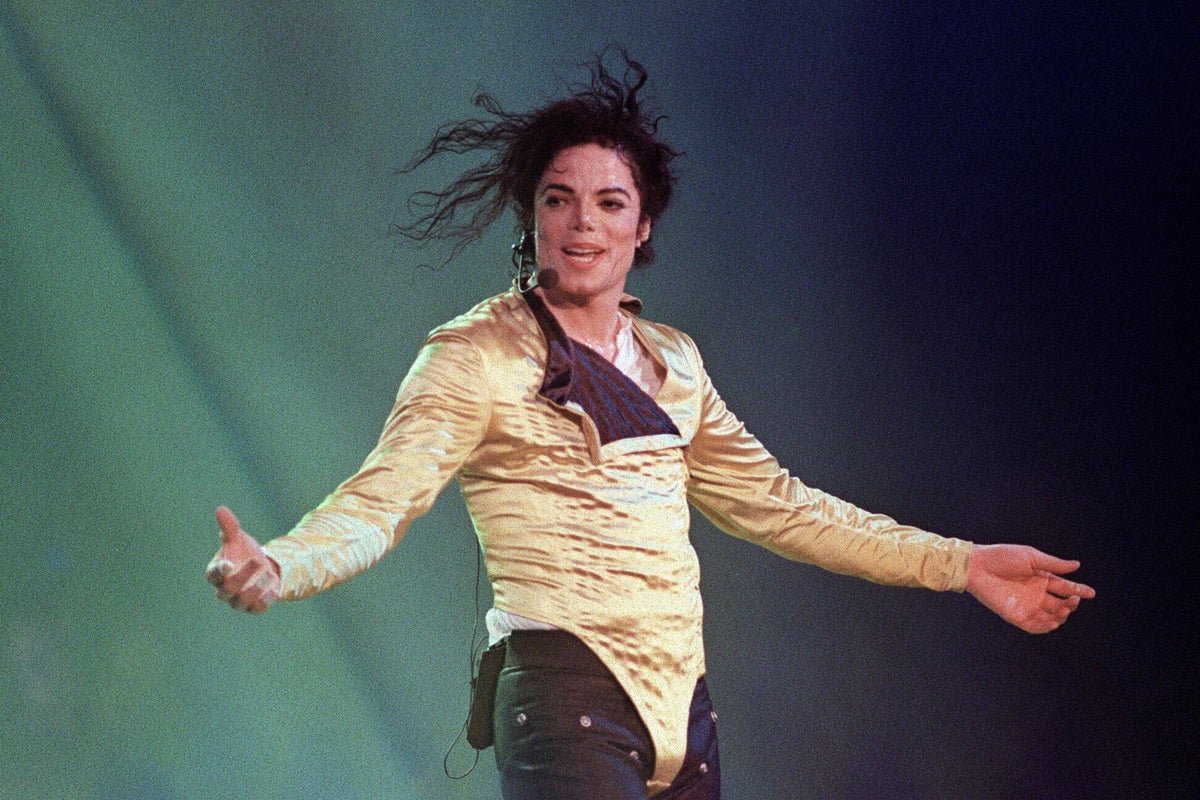 A photo of Michael Jackson performing on stage, with a crowd of fans in the background, as the primary keyword 'Michael Jackson' is naturally included in the descriptive alternative text for the featured image, which is about the singer's legacy and behaviour
