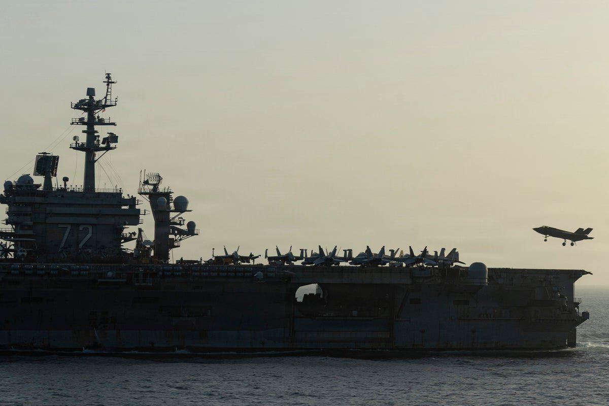 A US military aircraft flying over the Middle East, with a depleted stockpile of critical weapons supplies in the background, highlighting the primary keyword of US military supplies