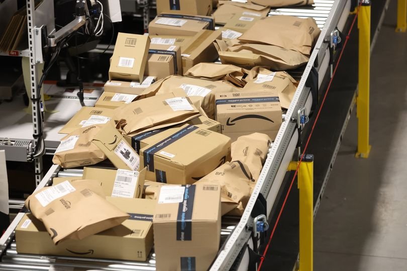 A person in a cleaner's uniform standing in front of an Amazon warehouse, with a discarded juice carton nearby, highlighting the incident that led to their unfair dismissal from the company, with a focus on employee rights and company policy