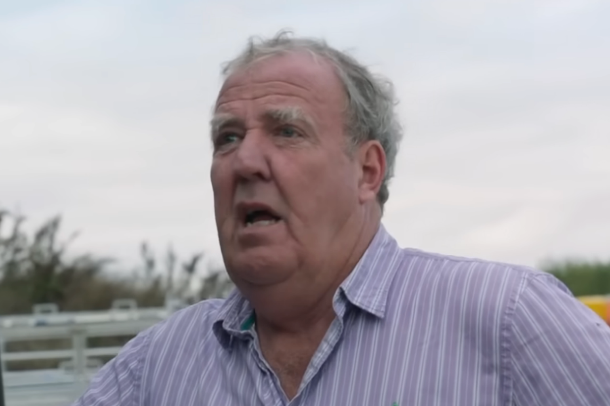 Jeremy Clarkson standing in a field, surrounded by countryside landscapes, with a tractor in the background, showcasing the beauty of farming life, Clarkson's Farm