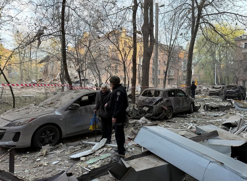 Aerial view of damaged buildings in Dnipro, Ukraine, following Russian forces' attacks, with smoke and flames billowing into the air, as the international community calls for an end to the conflict in Ukraine