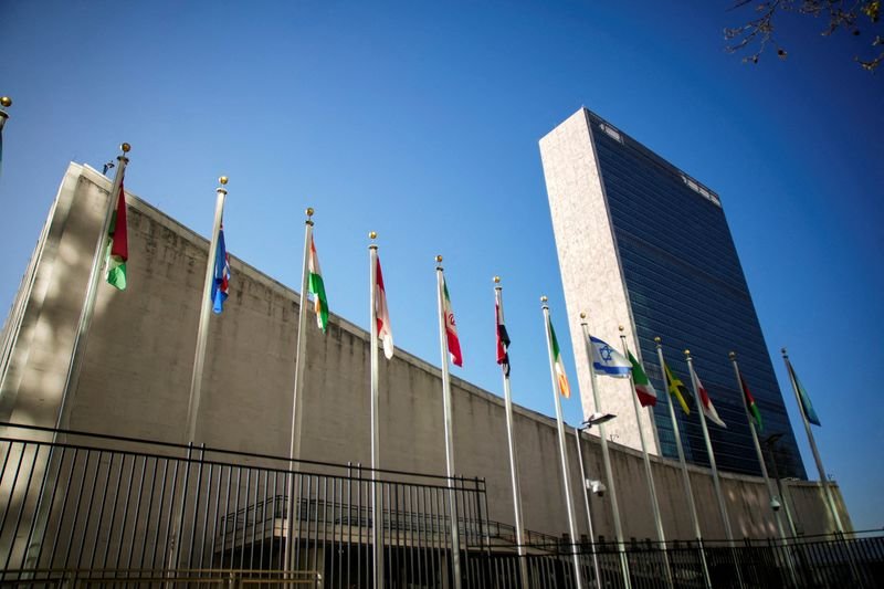 The United Nations headquarters in New York, with the US and Iranian flags in the foreground, symbolising the clash between the two nations over nuclear non-proliferation, a critical issue for global security and stability, with the UN playing a key role in facilitating dialogue and finding a resolution