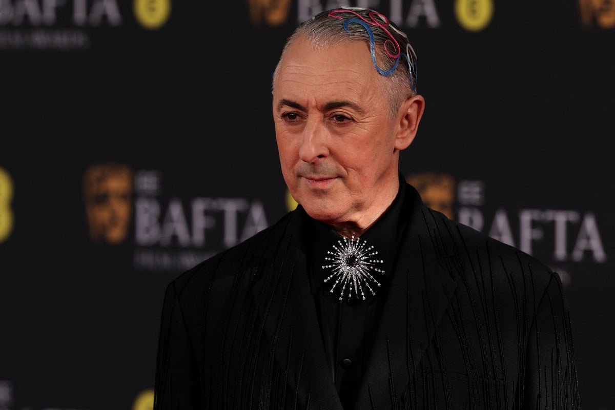 Alan Cumming attends a red carpet event, highlighting the importance of inclusivity and understanding in the entertainment industry, particularly for individuals with neurological disorders like Tourette's syndrome