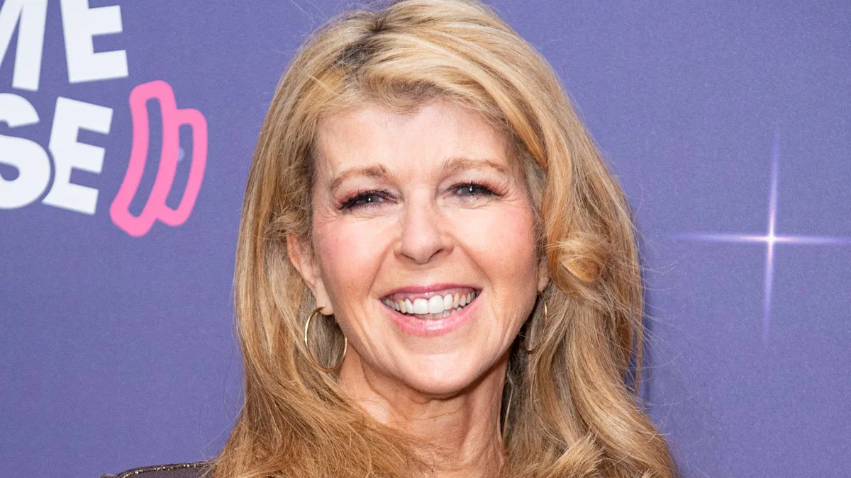 Kate Garraway smiling, surrounded by loved ones, as she navigates the complexities of grief and relationships, finding solace in the support of those around her, with a deep understanding of the importance of human connection and mental health