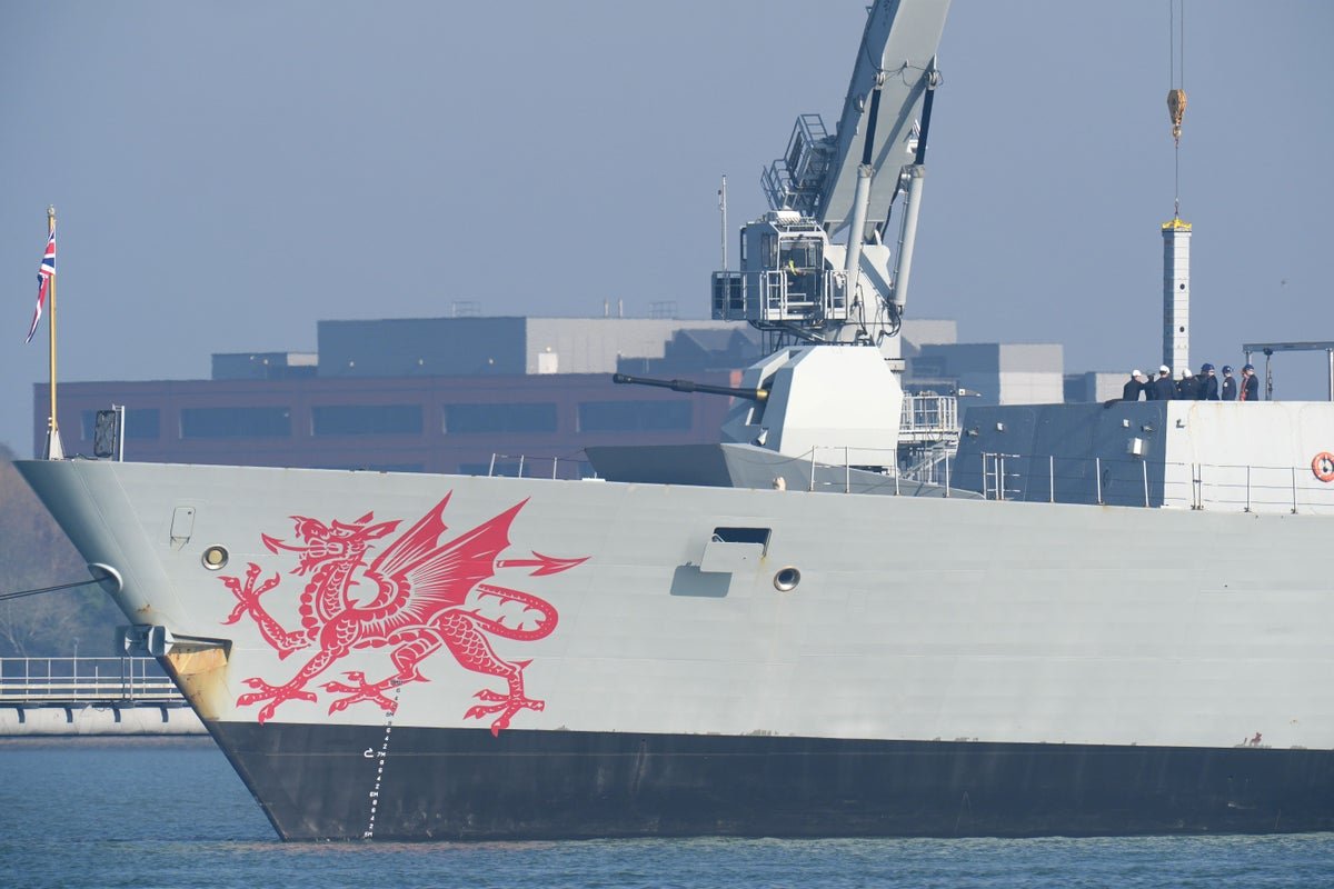 A British warship navigates the Strait of Hormuz, a critical shipping lane with significant economic and political implications, as Iran issues a warning of a decisive response to any aggression, with the UK and international community closely monitoring the situation