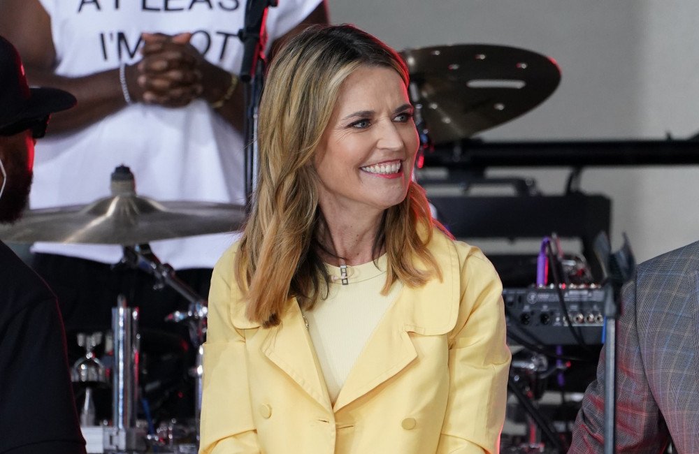 A photo of Savannah Guthrie with a heartfelt expression, symbolizing her unwavering dedication to finding her missing mother, with a subtle background of a missing person's poster, including the primary keyword 'missing persons'