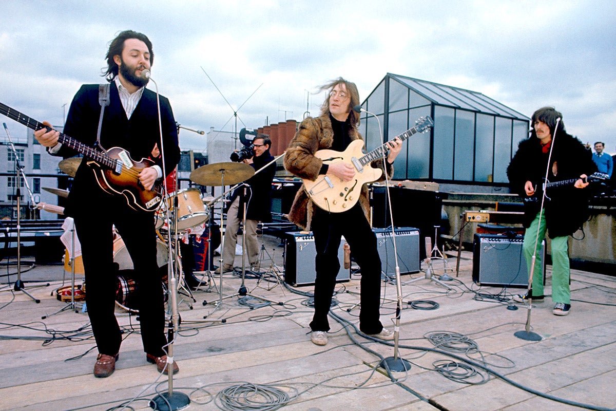 The Beatles performing on the rooftop of the Apple Records building, a historic moment in music history that will be remembered forever, with the primary keyword being The Beatles' final performance