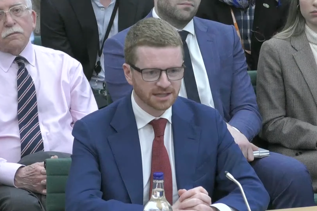 A person holding a phone with a concerned expression, symbolising the threat of phone theft and the importance of being cautious in public, with a focus on the Morgan McSweeney case