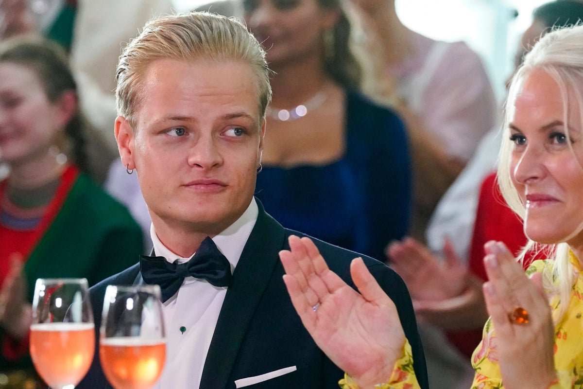 Norwegian crown princess's son in court, awaiting verdict in rape trial, with a serious expression, surrounded by his legal team, in a crowded courtroom, with a judge's bench in the background, highlighting the primary keyword phrase 'rape trial'
