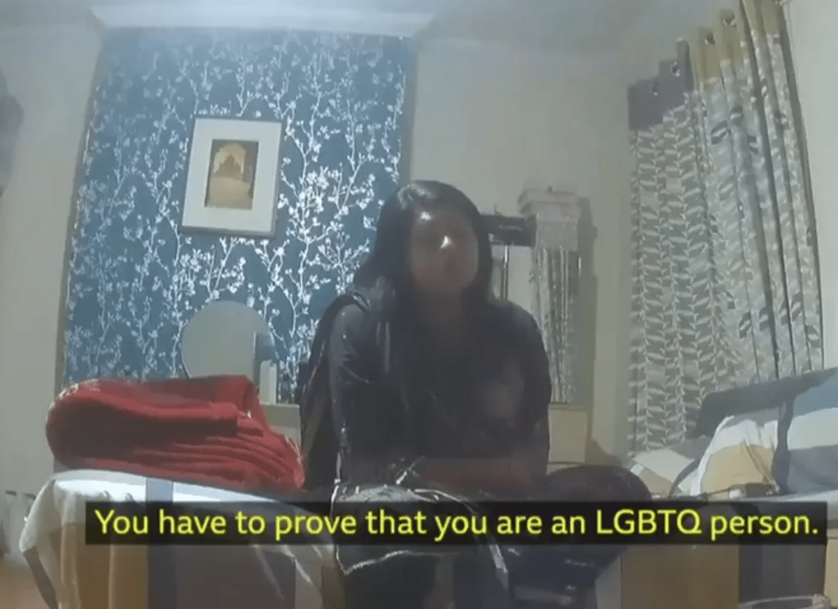Image of a person holding a fake visa, with a caption describing the fake gay visas scam in east London, highlighting the primary keyword of immigration scam