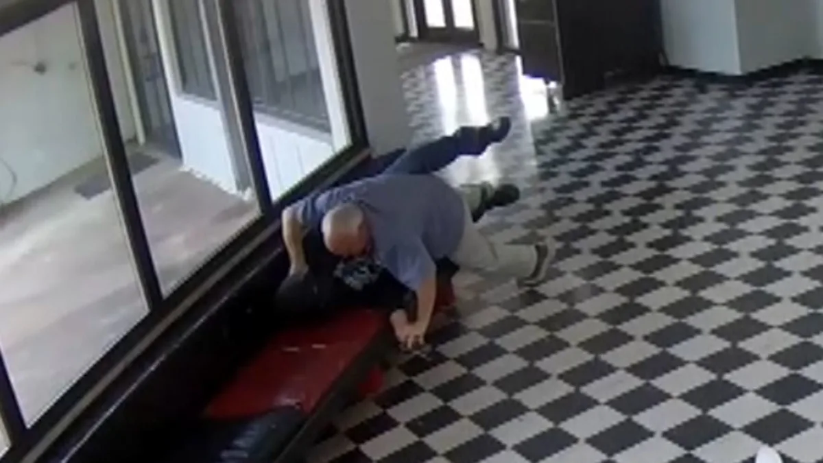 US high school principal tackling an armed individual, demonstrating bravery and selflessness in a crisis situation, with a focus on school safety and crisis management