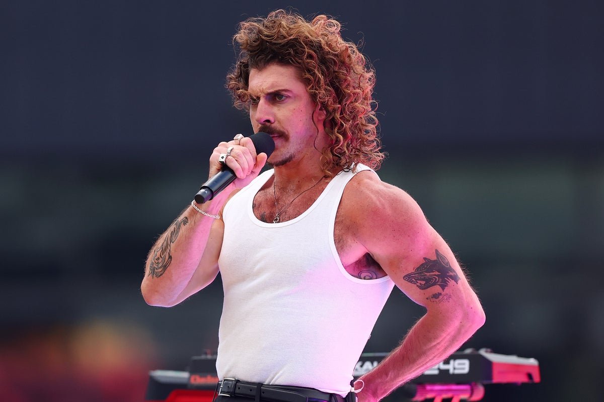 Australian singer Keli Holiday performs on stage, her music and message promoted through social media, amid US entry denial controversy over Trump post, with fans and fellow musicians showing support