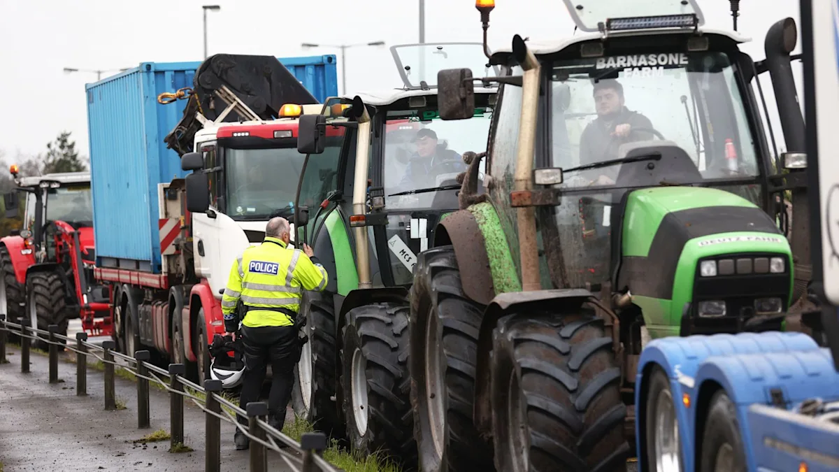 A group of protesters holding signs that read 'Fair Fuel Prices Now' and 'Sustainable Energy for All', with a backdrop of fuel pumps and cars. The image captures the essence of the UK fuel price crisis, with people from all walks of life coming together to demand change. The primary keyword, fuel prices, is naturally included in the descriptive alt text.