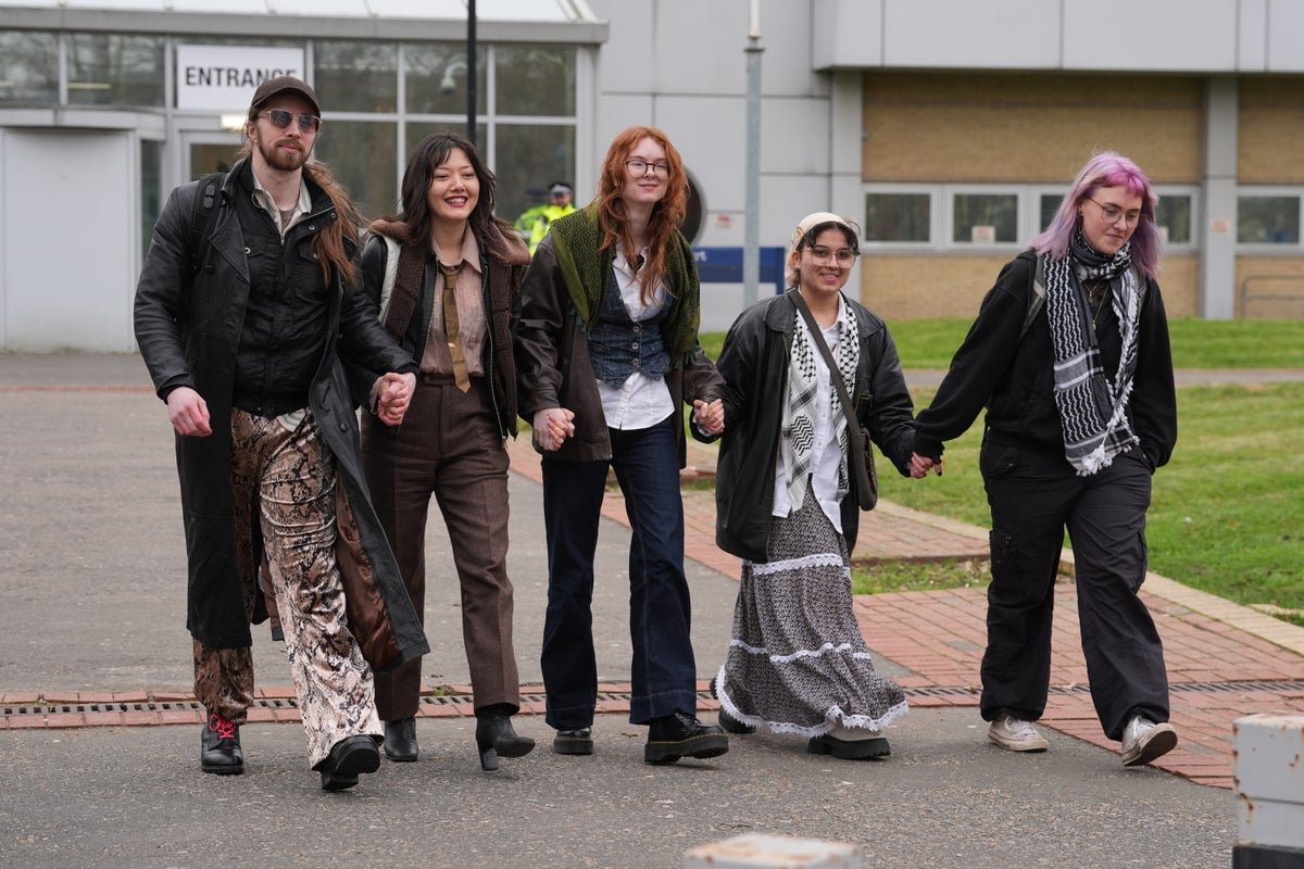 Palestine Action activists protesting outside a defence factory, highlighting the primary keyword of activism and the use of direct action to disrupt the production of military equipment, with a focus on the colour and behaviour of the protest