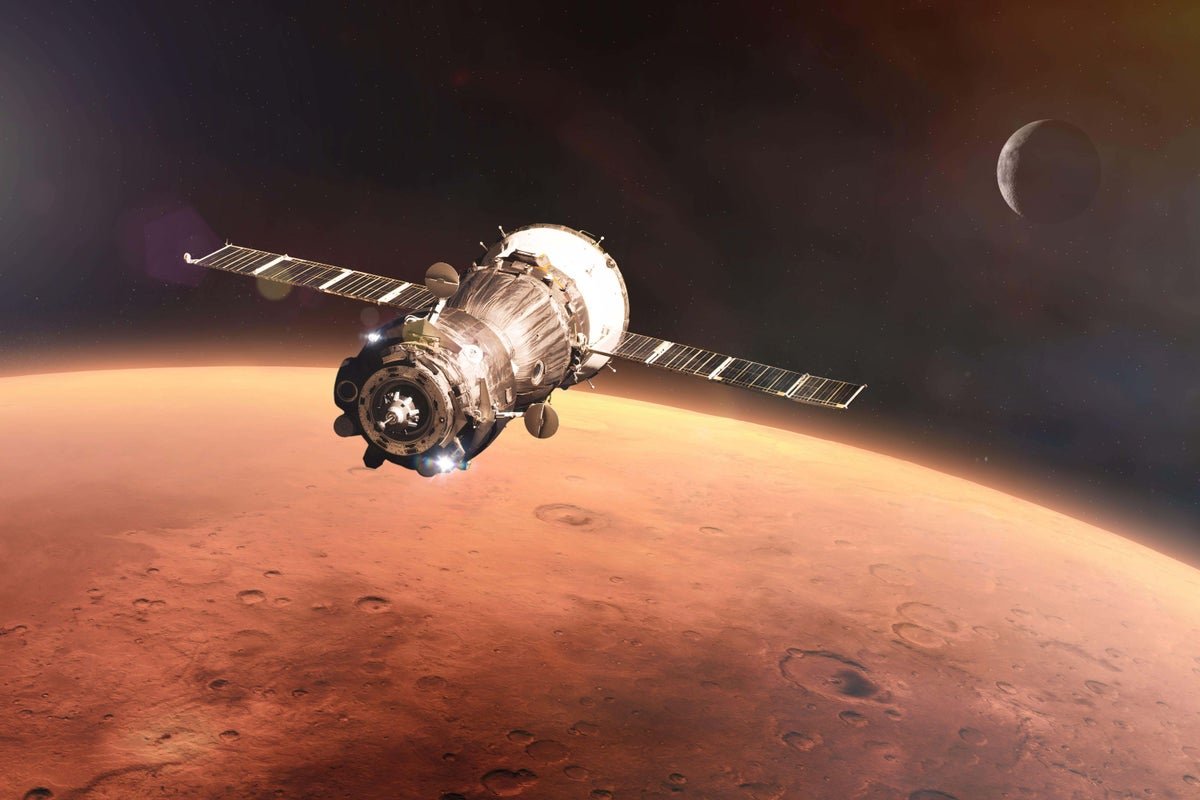 NASA spacecraft approaching Mars in pursuit of rare metal asteroid, with the planet's surface visible in the background, showcasing the asteroid's unique colour and shape