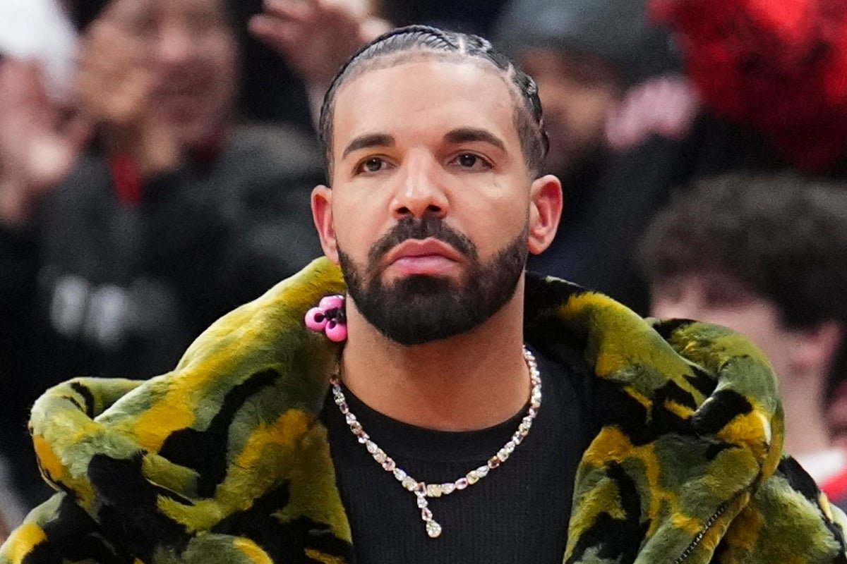 Drake performing on stage, surrounded by adoring fans, with a captivating stage presence that belies his 'loser' persona, highlighting the complexities of his behaviour and its impact on the music industry