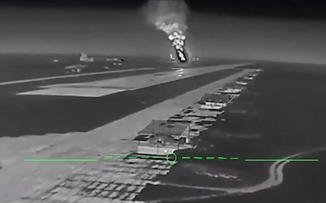 A Ukrainian drone flying over a Russian airbase, with a destroyed aircraft in the background, highlighting the devastating impact of drone warfare on modern military capabilities