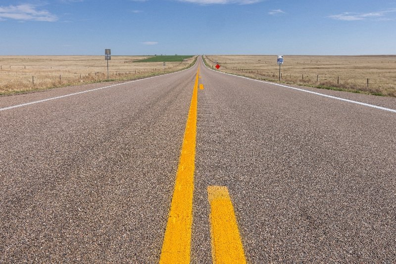 A descriptive image of rural landscape with a subtle hint of military presence, symbolising the complex interplay between national security and economic well-being, with the primary keyword 'Iran war' naturally included in the context of rural voters' support