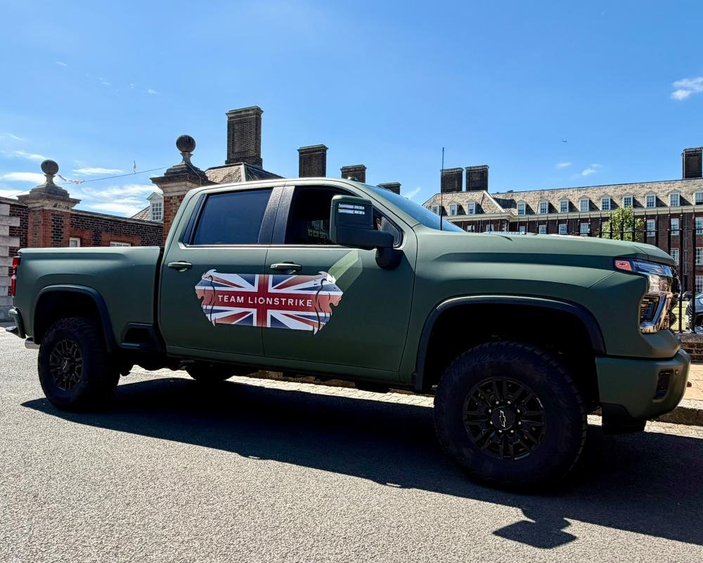 A fleet of military trucks on a training exercise, with soldiers in uniform and vehicles equipped with advanced technology, showcasing the latest innovations in the defence industry, with a focus on military trucks and vehicles